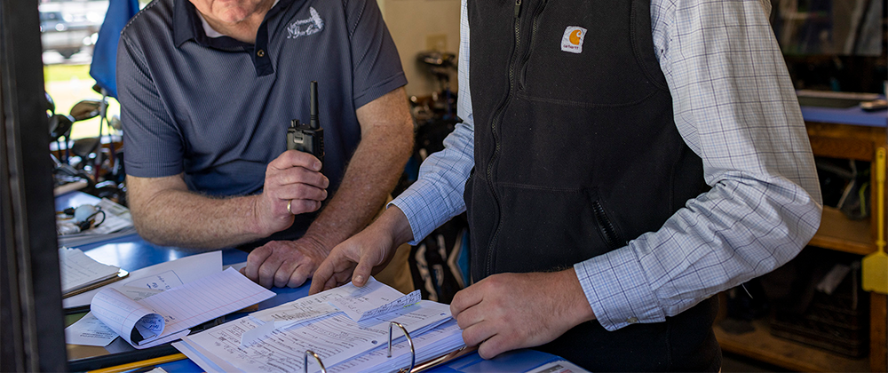 Two men looking over documents.